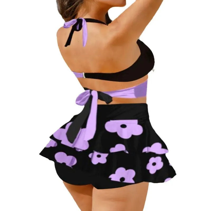 Women's purple bikini swimsuit with matching skirt showing lace-up design and high-waist brief style