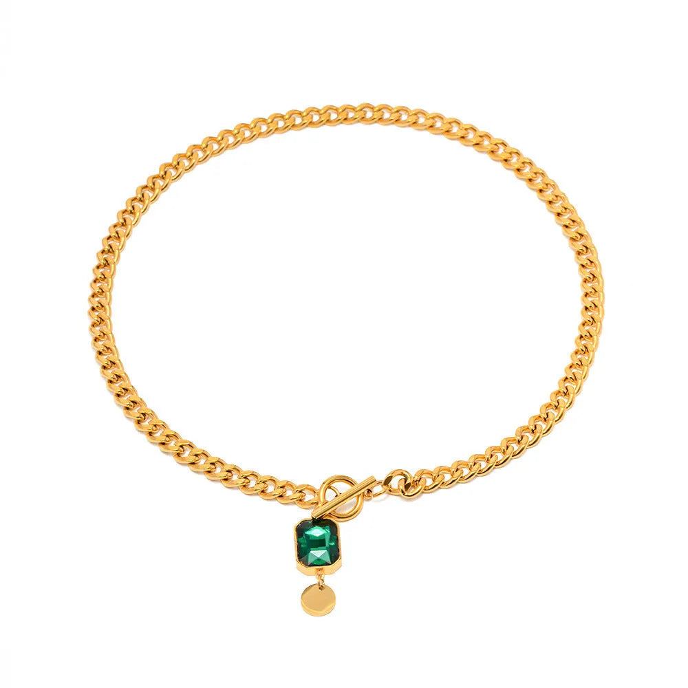 Gold titanium steel necklace with geometric pendant containing emerald zircon stone
