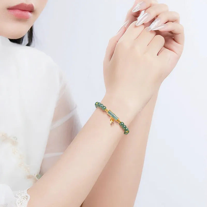 Blue water natural jade beads on a sterling silver high-rise bracelet for women.