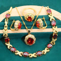 Gold plated jewellery set with coloured cubic zirconia stones showing necklace, earrings, ring, and bracelet.