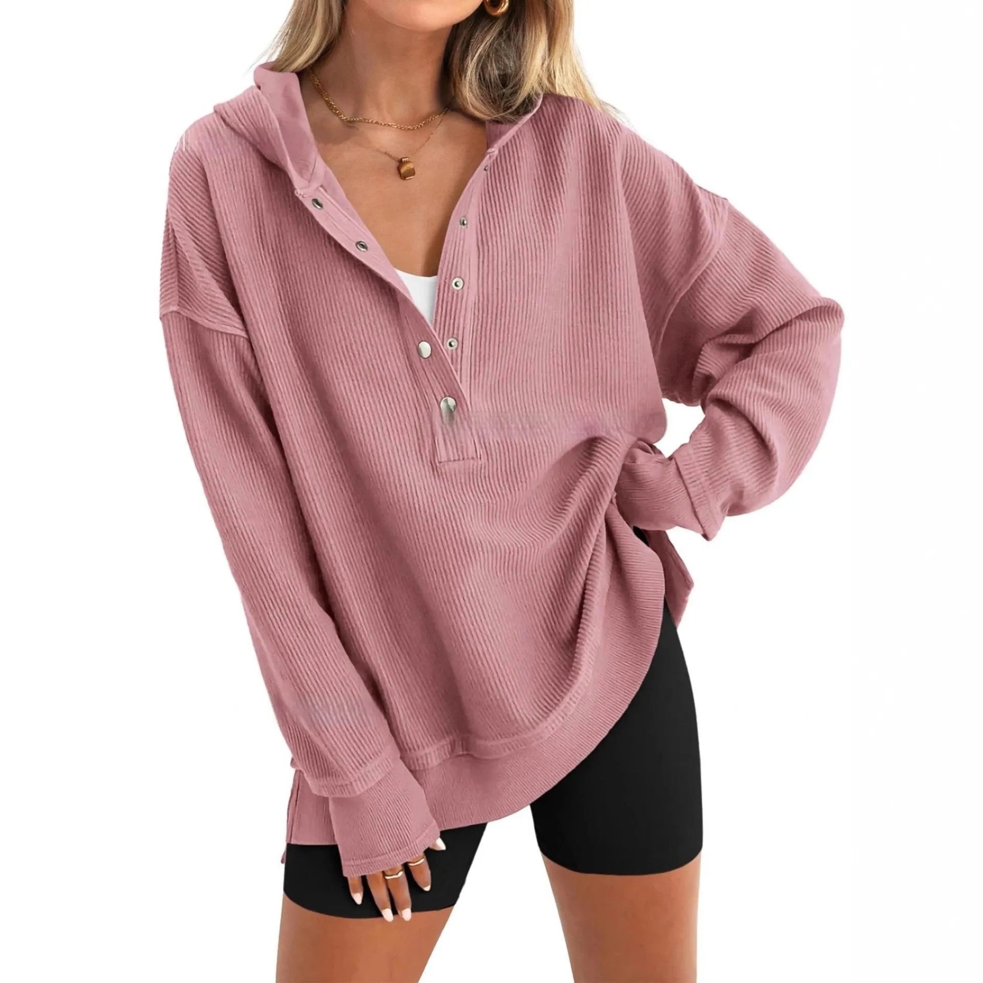 Women's loose fit peach coloured raglan sleeve pullover sweater on a hanger.