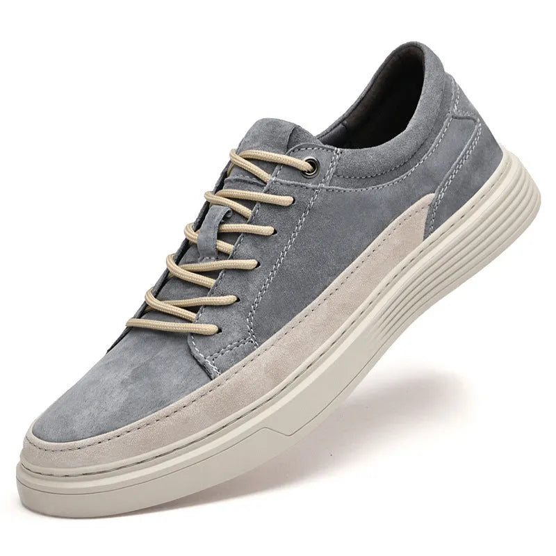 Men's grey pigskin leather low-top casual skate shoes with round toe and flat rubber sole.