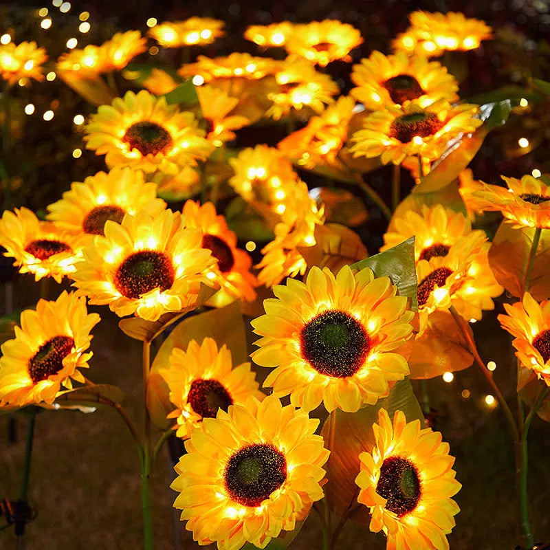 Solar sunflower lawn lamp with three sunflower heads on stainless steel stem in garden
