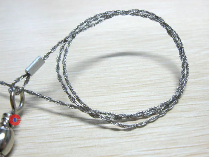 Stainless steel survival wire saw with pull rings, showing coiled 55 cm blade.
