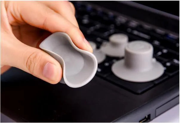 Grey durable plastic laptop cooling pad kit with two large and two small non-slip pads.