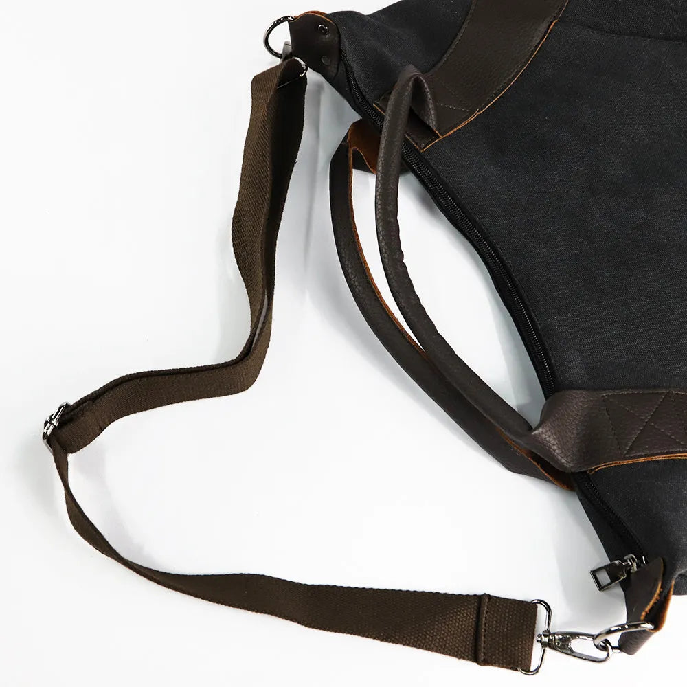Women's canvas handbag in lake blue with zipper closure, hard handle, and double strap roots for shoulder or crossbody carry