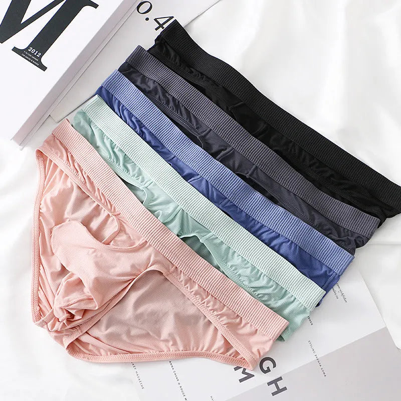 Men's low waist briefs underwear in ice silk nylon fabric on a colour swatch showing black, grey, purple blue, light green and pink.