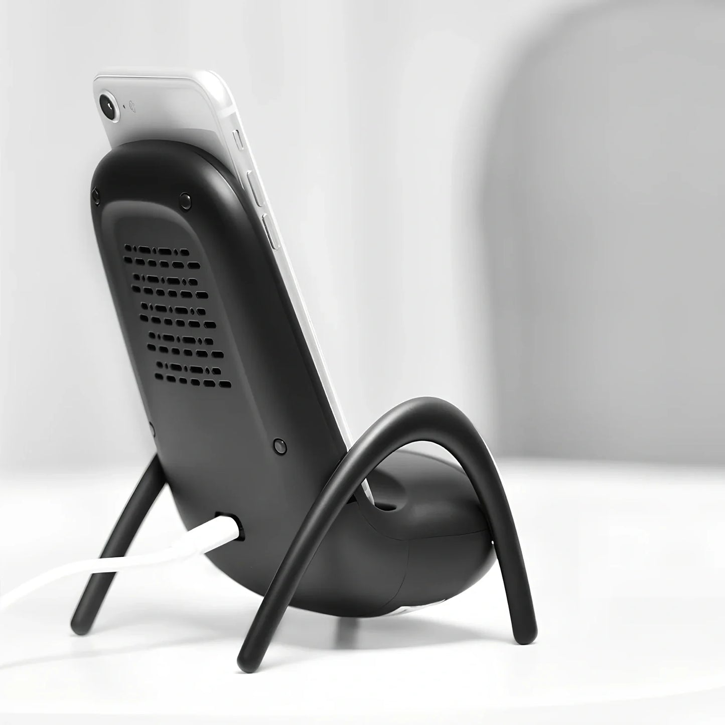 Black amplified wireless charger with bracket, 9.8 x 9.8 x 14.2 cm, for phone charging and audio boost