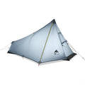 Silicon coated outdoor camping pyramid tent in green pitched on grass showing fly and aluminium pole
