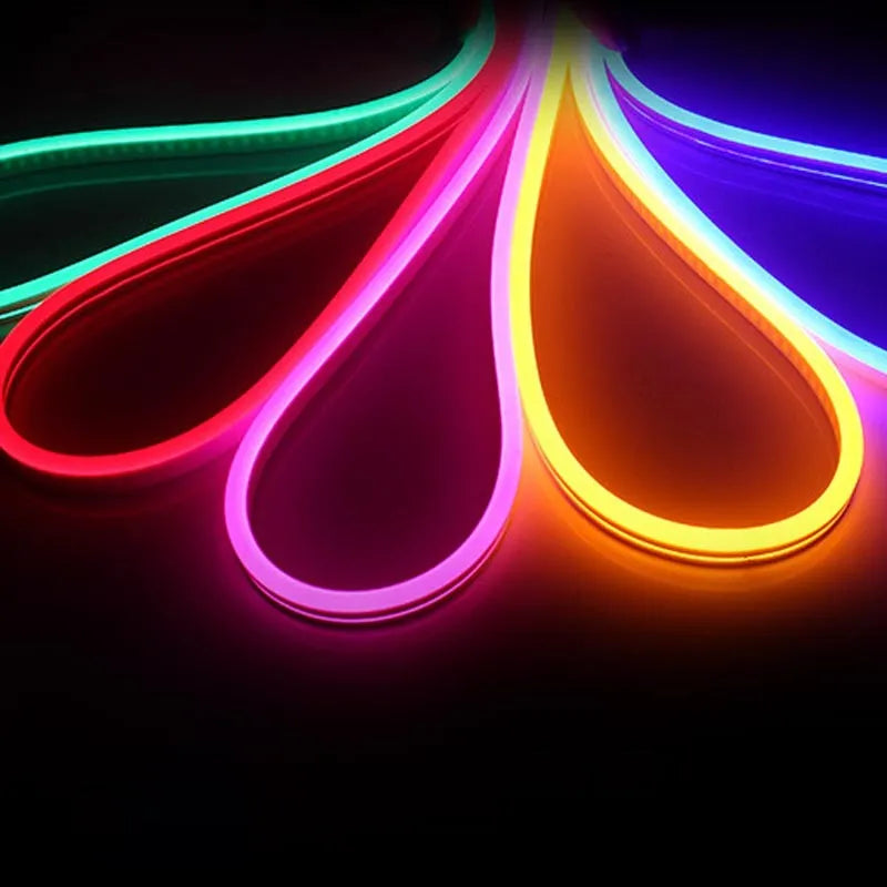 A 100-metre reel of flexible blue LED neon strip light showing its bendable silicone construction and bright illumination.