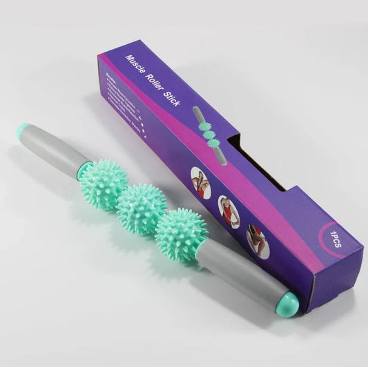 Green anti-cellulite massager stick with hedgehog-shaped balls and ergonomic handle for deep tissue massage