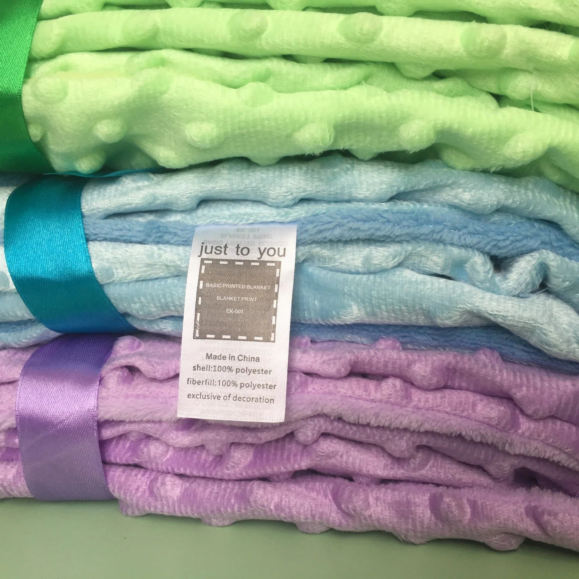 Soft and cozy baby blanket in various colors, including white, blue, gray, purple, green, and pink, with a plush, short-pile fabric and luxurious lamb velvet backing