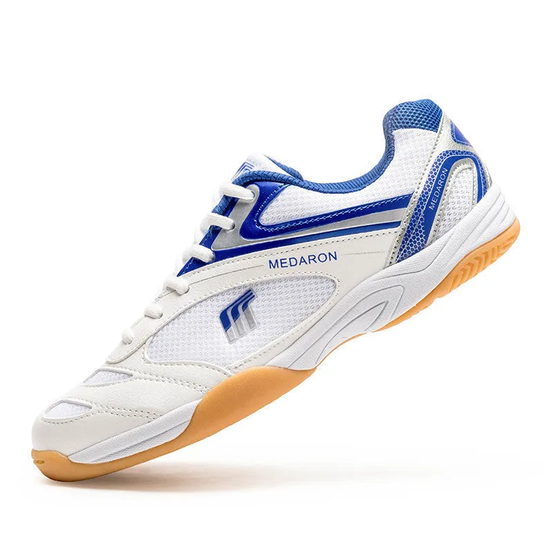 White and red mesh table tennis sneakers with rubber sole and lace-up front.