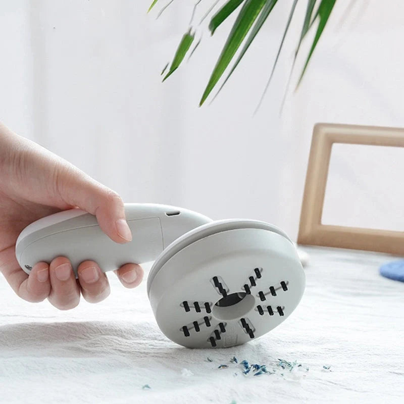 Mini desktop vacuum cleaner in pink, green, blue, and grey for dust removal