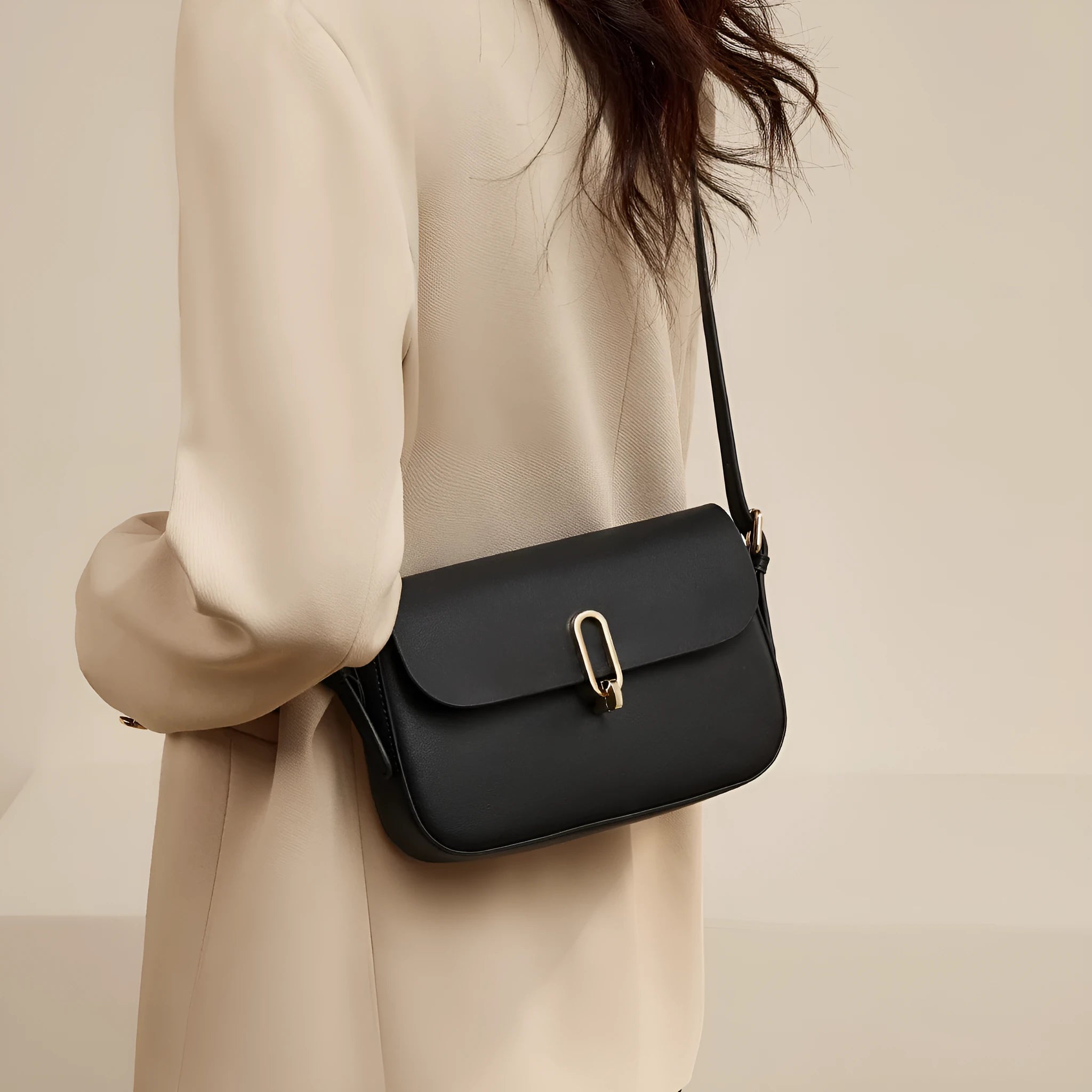Square leather messenger bag in black with shoulder strap and lock fastener