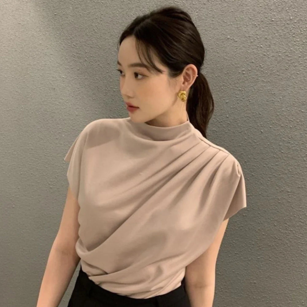 Women's apricot shirt with stand-up collar, diagonal pleats, and flowing short sleeves on hanger