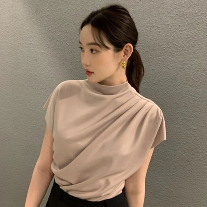 Women's apricot shirt with stand-up collar, diagonal pleats, and flowing short sleeves on hanger