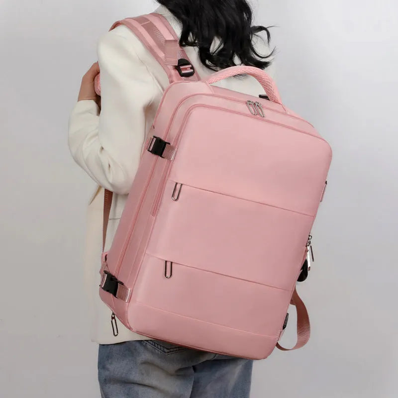 Women's large capacity travel backpack in purple with multiple compartments and air pillow belt