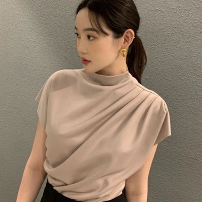 Women's apricot shirt with stand-up collar, diagonal pleats, and flowing short sleeves on hanger