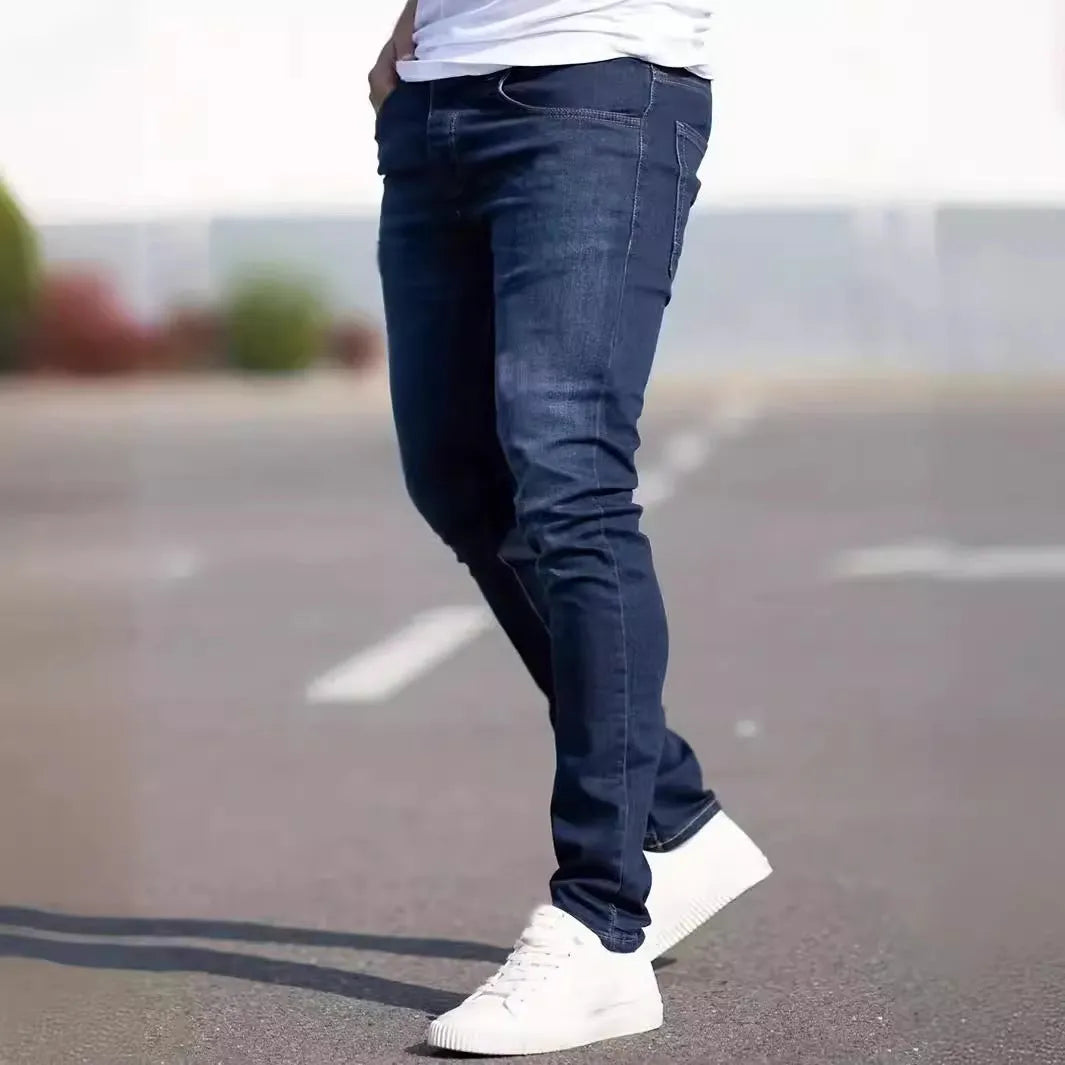 Men's dark blue slim-fit elastic cotton jeans with a skinny leg opening.