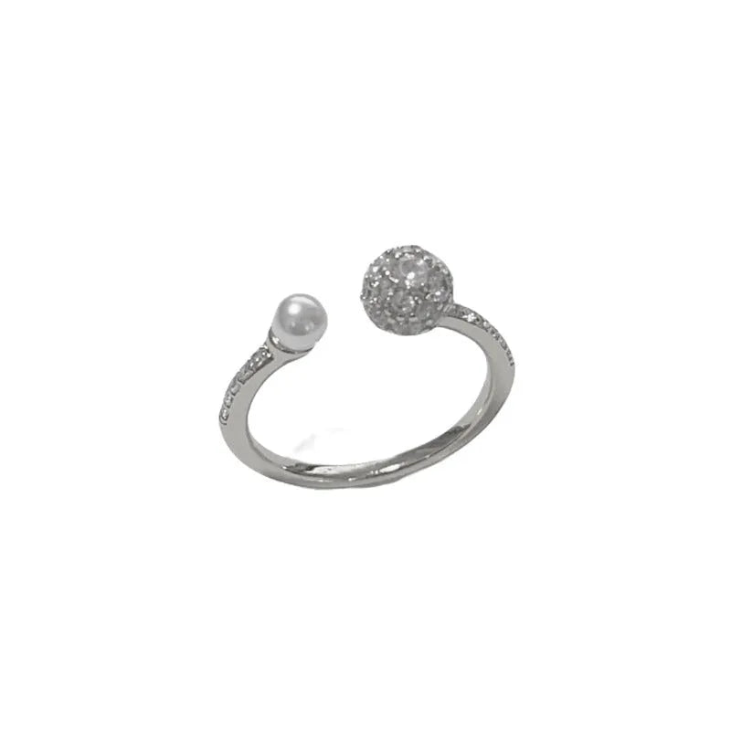 Open-end pearl ring with round zircon stone in gold or silver colour, showing geometric shape and thick real gold plating.