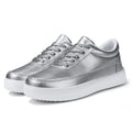 Women's white leather casual flat shoes with front lace-up design on a plain background.