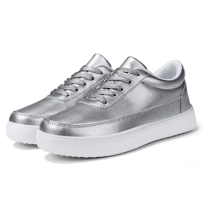 Women's white leather casual flat shoes with front lace-up design on a plain background.