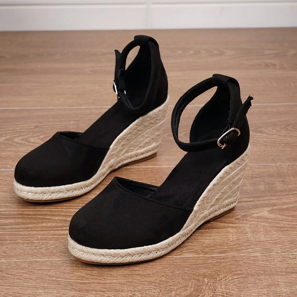 Women's apricot and black suede Roman-style wedge sandals with buckle and rubber sole.