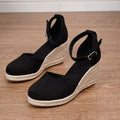 Women's apricot and black suede Roman-style wedge sandals with buckle and rubber sole.