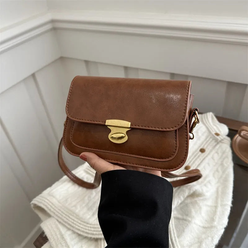 Small soft PU leather square handbag in retro design, shown in a neutral colour.