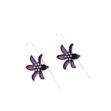 A pair of retro-style purple flower-shaped alloy earrings for women on a plain background.