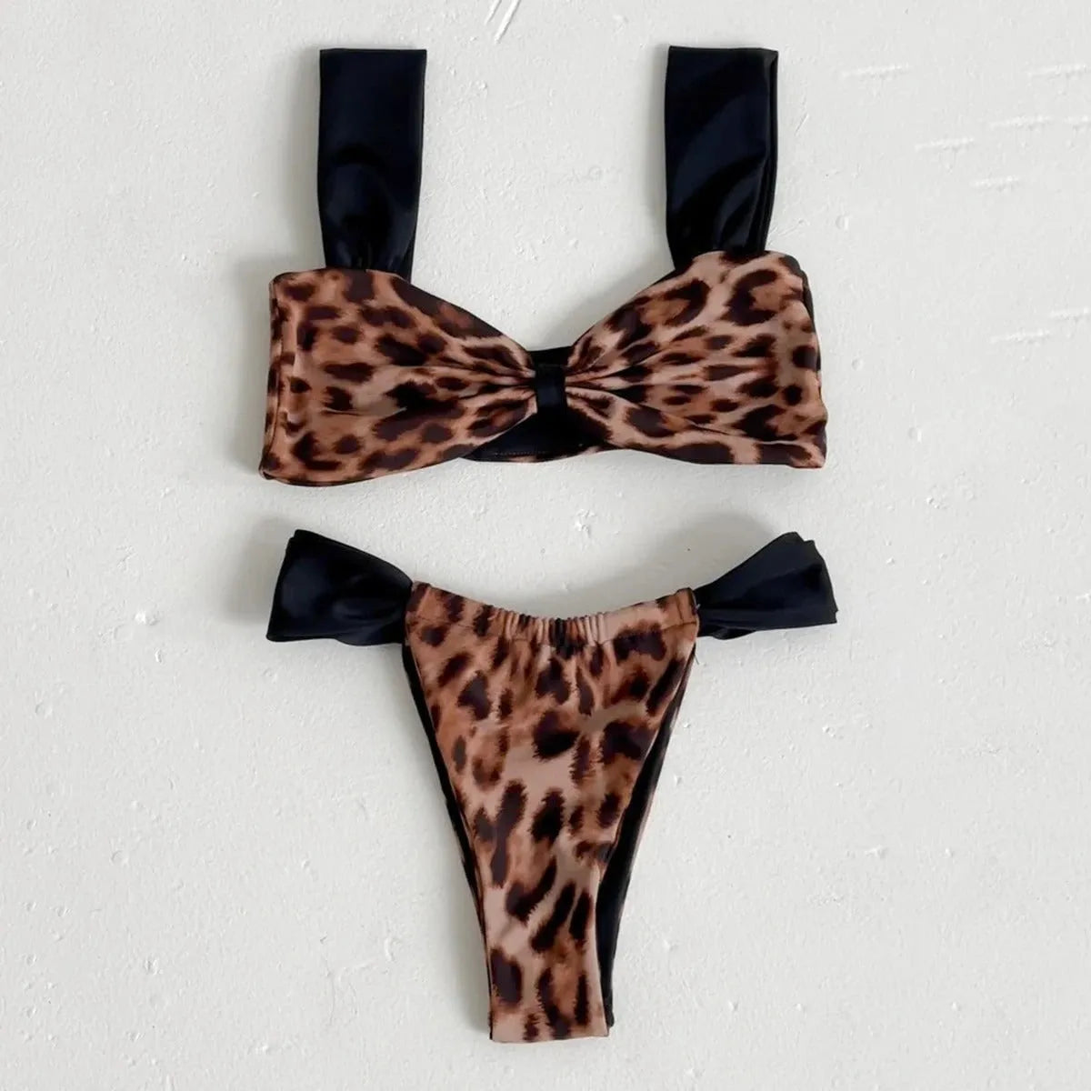 Black women's bikini with leopard print tube top and matching split T-back pant.