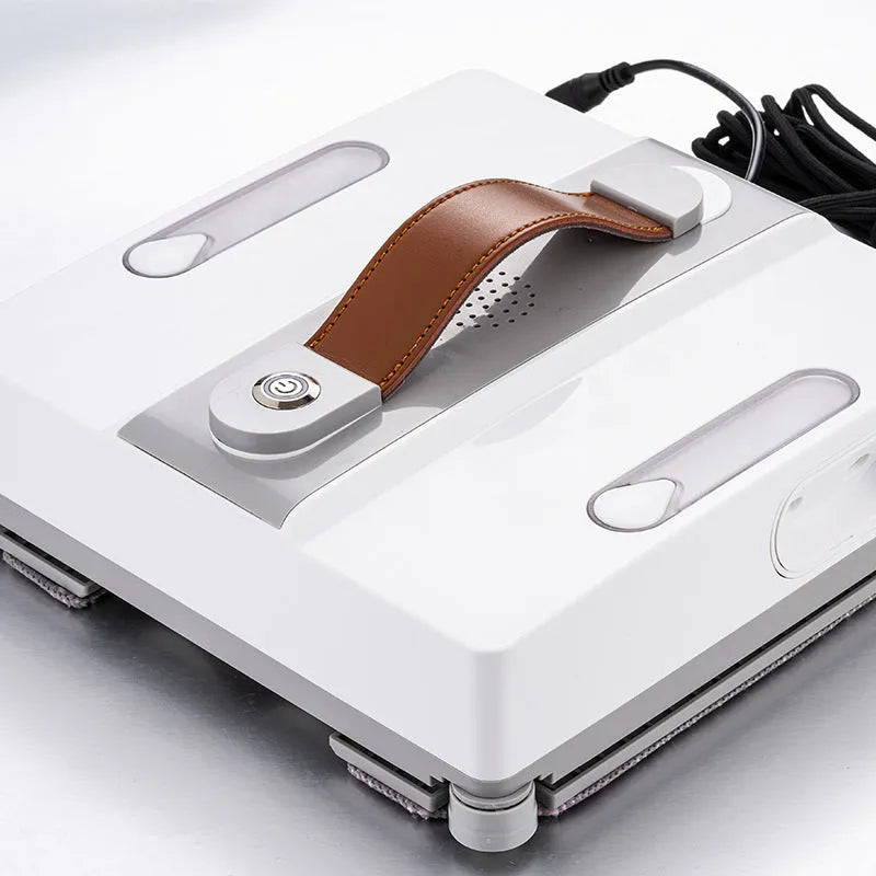 White square window cleaning robot with water spray nozzles on a glass window pane.