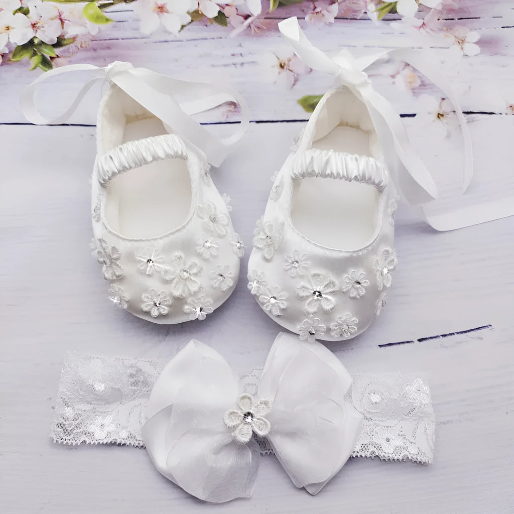 White baby soft bottom cloth princess shoes with rhinestone detail on a white background