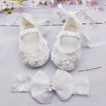 White baby soft bottom cloth princess shoes with rhinestone detail on a white background