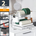 White double-layer metal kitchen draining rack with a removable top tray on a countertop.