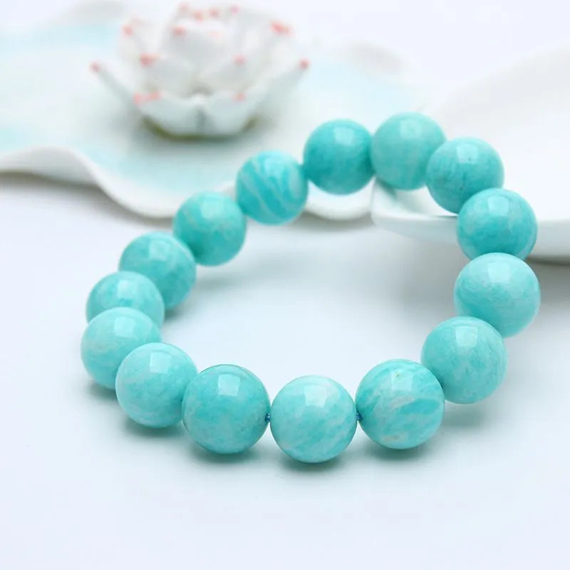 Natural blue-green Amazonite stone bracelet with round beads on an adjustable cord.