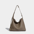 Large soft PU messenger bag in caramel colour showing shoulder strap and dimensions