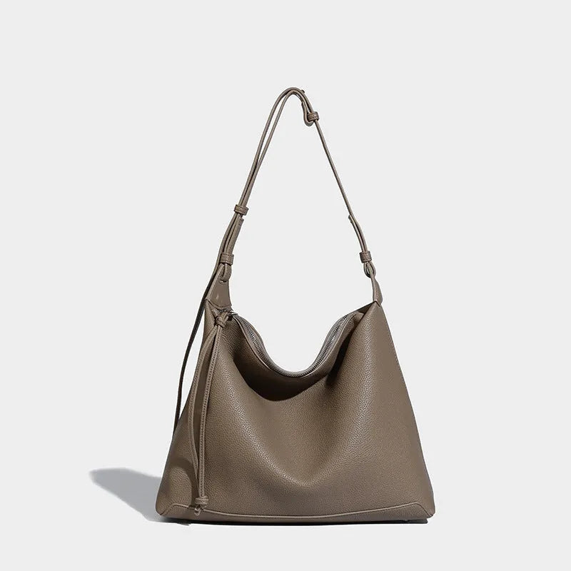 Large soft PU messenger bag in caramel colour showing shoulder strap and dimensions