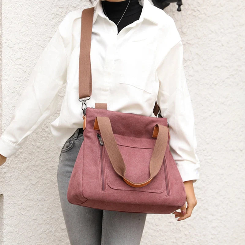 Women's canvas shoulder bag in multiple colours, showcasing spacious interior and zipper closure.