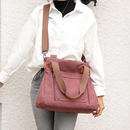 Women's canvas shoulder bag in multiple colours, showcasing spacious interior and zipper closure.
