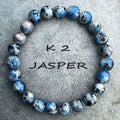 Handmade blue-green K2 Azurite stone bracelet with geometric beads on a wrist.