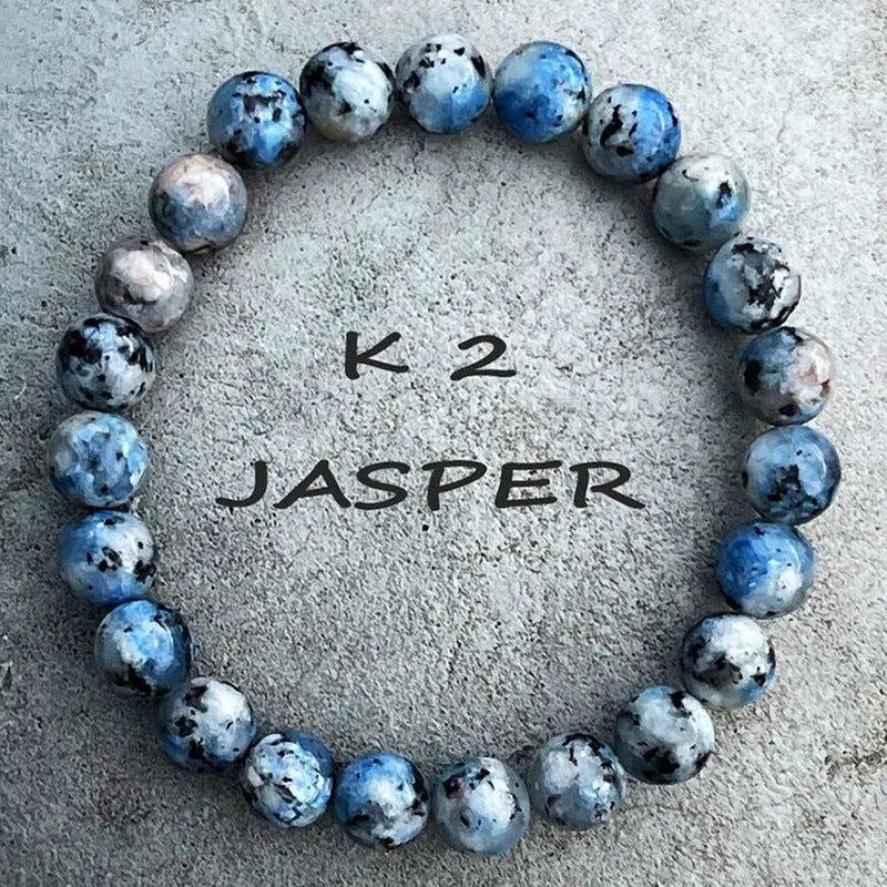 Handmade blue-green K2 Azurite stone bracelet with geometric beads on a wrist.