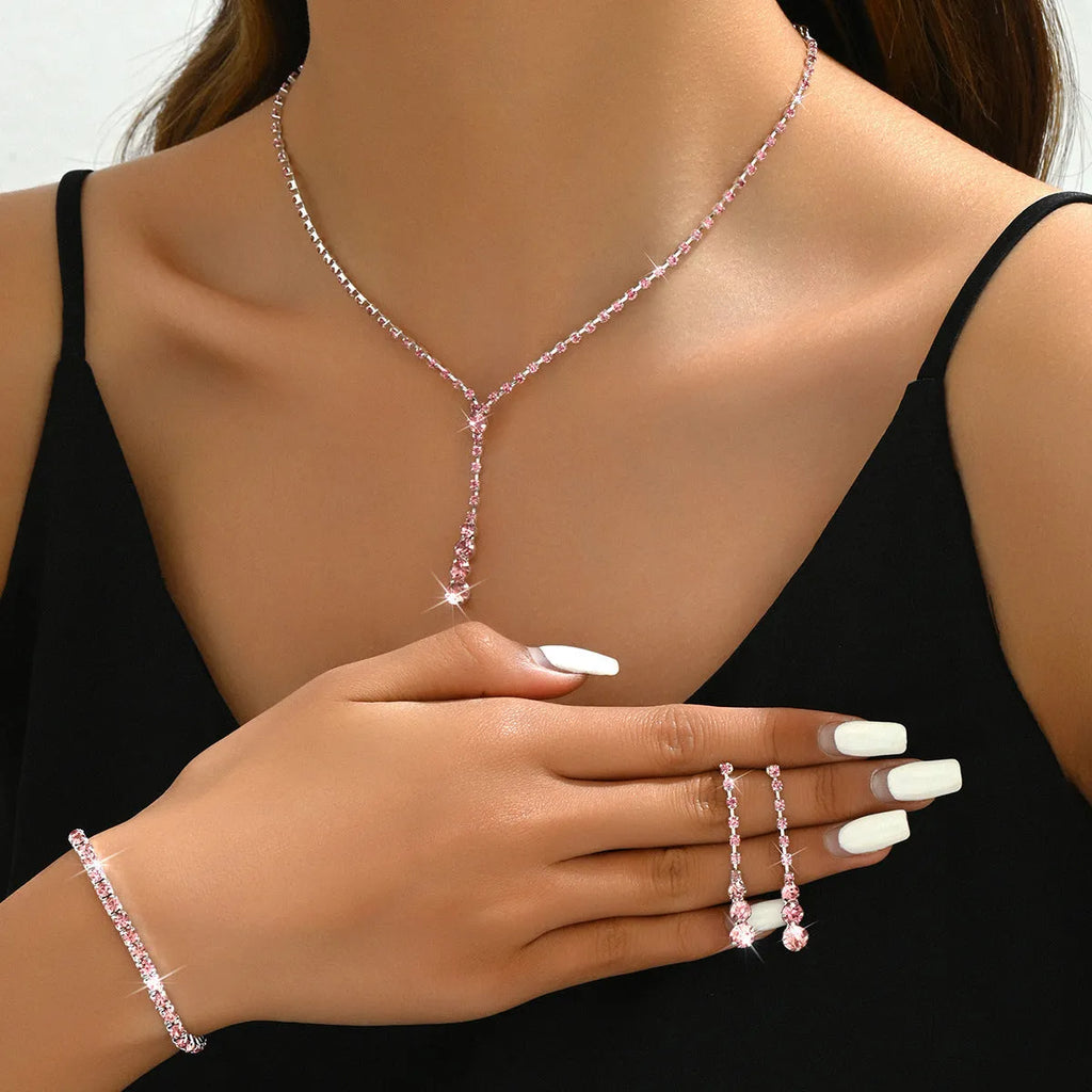 Bridal jewellery set with rhinestone heart necklace, elastic bracelet, and matching earrings with tassel details