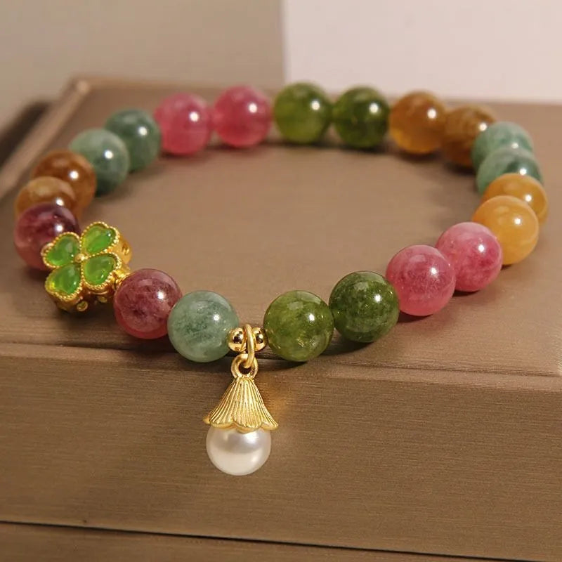 Coloured tourmaline bracelet with four-leaf clover pearl charm and geometric drop beads