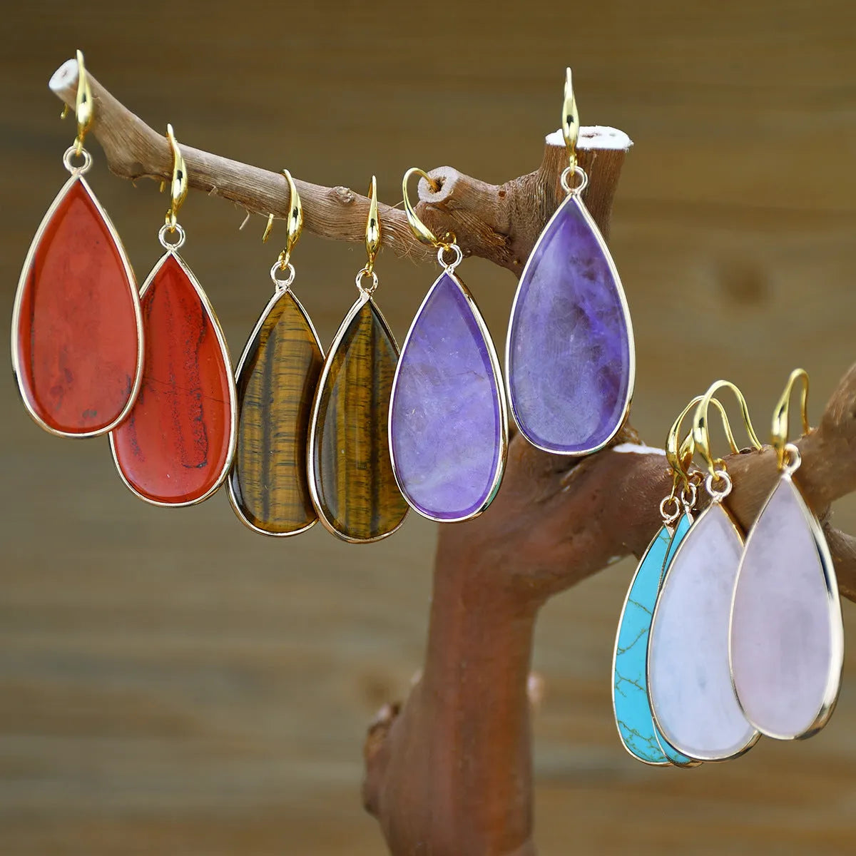 Vintage Tigereye long water drop stone earrings showing textured surface and elongated silhouette