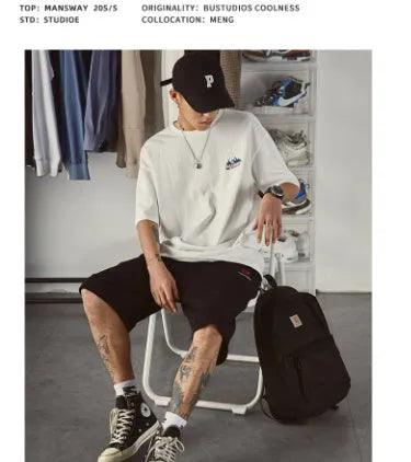 Men's loose fit plus size short-sleeved t-shirt in black, on a hanger.