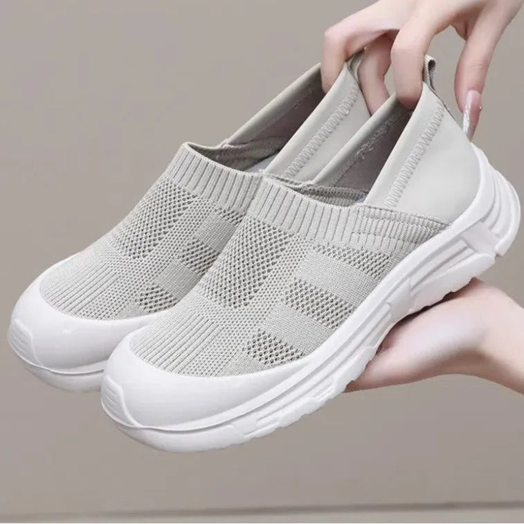 Women's black oversleeve shoes with round toe and soft flat PVC sole.