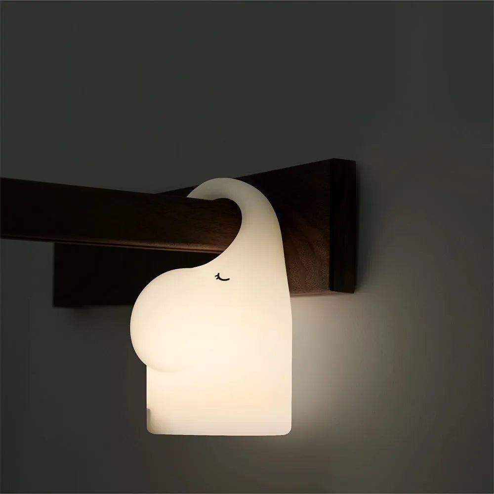 White DOMI elephant-shaped cordless silicone night light on a surface.
