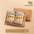 Two pairs of thick midsole Merino wool socks in a solid colour, presented inside a gift box.